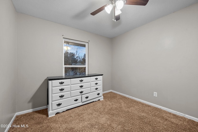 bedroom with a textured ceiling, carpet floors, and ceiling fan