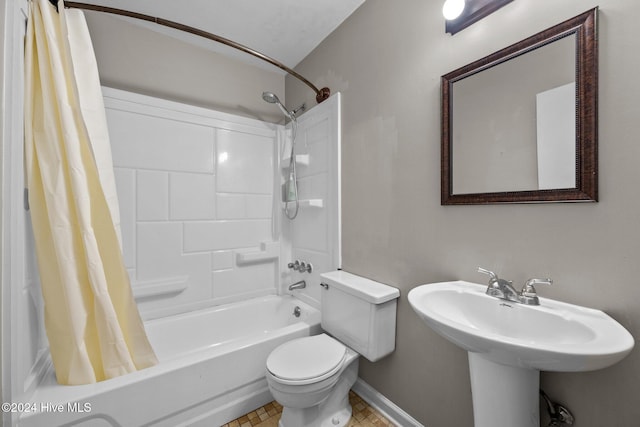 full bathroom with tile patterned floors, toilet, shower / bath combo with shower curtain, and sink