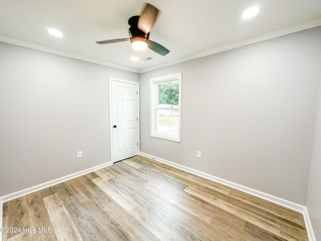 spare room with light hardwood / wood-style floors, ceiling fan, and crown molding