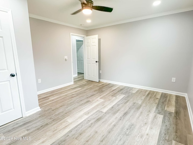 empty room with light hardwood / wood-style floors, ceiling fan, and crown molding