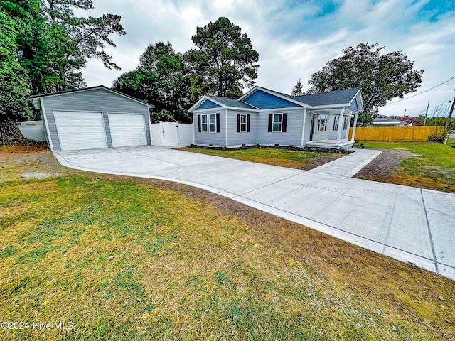 ranch-style house with a garage, an outdoor structure, and a front lawn