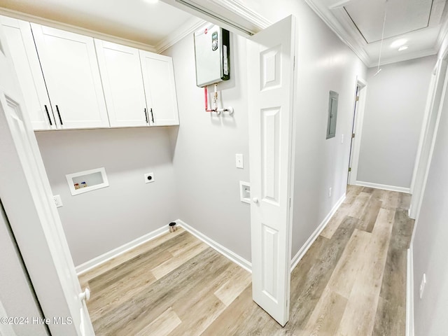 washroom featuring ornamental molding, hookup for a washing machine, cabinets, light hardwood / wood-style floors, and electric dryer hookup