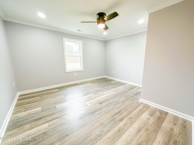 empty room featuring ceiling fan, light wood-type flooring, and ornamental molding