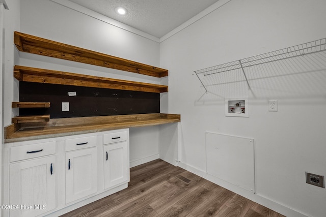 laundry area with electric dryer hookup, crown molding, washer hookup, a textured ceiling, and dark hardwood / wood-style flooring