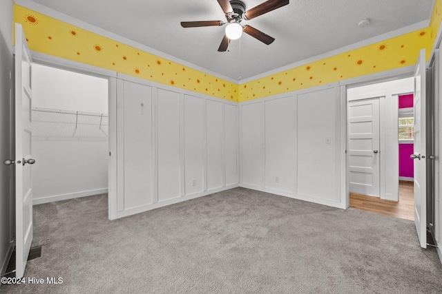 unfurnished bedroom with ceiling fan, a closet, and light colored carpet