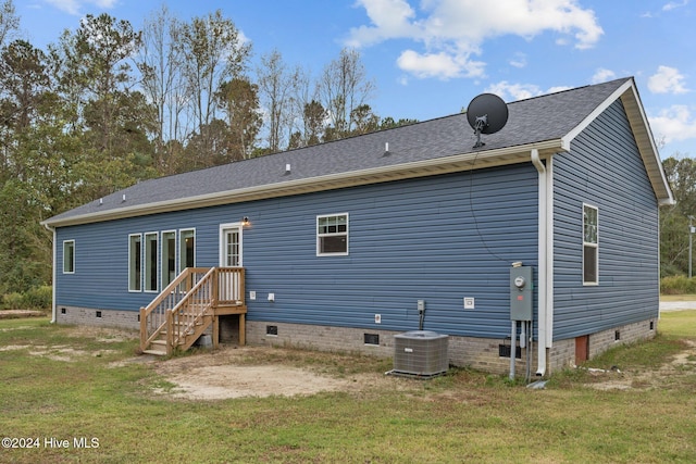 back of house with a yard and central AC unit