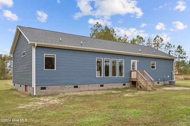 back of house featuring a lawn and cooling unit