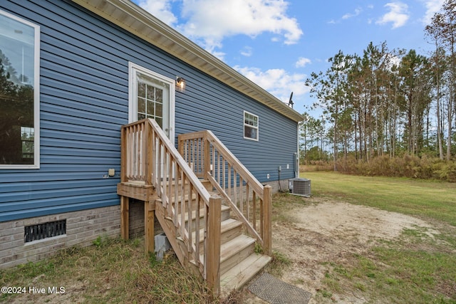 wooden terrace featuring central AC and a lawn