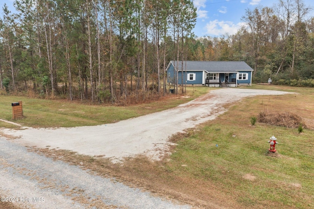 view of front facade with a front yard and covered porch