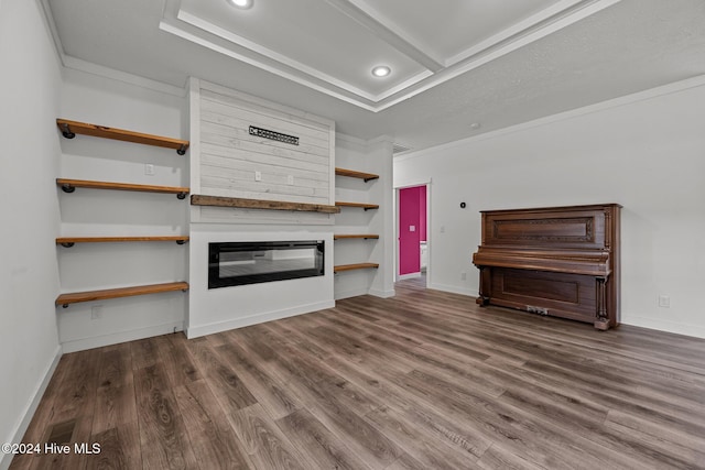 unfurnished living room featuring wood-type flooring and crown molding