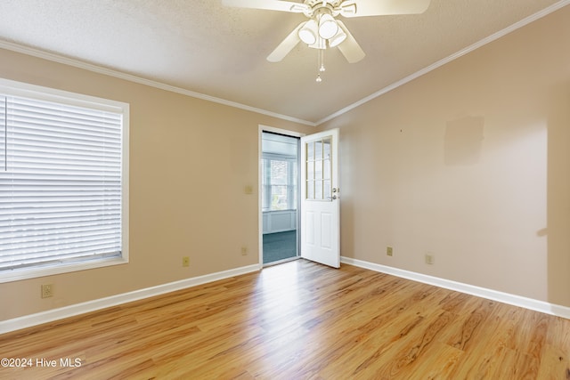 unfurnished room featuring ceiling fan, light hardwood / wood-style floors, a textured ceiling, and ornamental molding