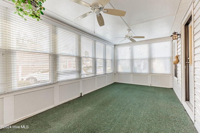 unfurnished sunroom featuring ceiling fan