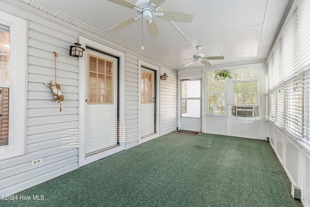 unfurnished sunroom with ceiling fan