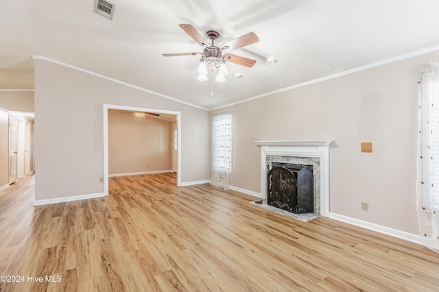 unfurnished living room featuring crown molding, ceiling fan, light hardwood / wood-style floors, and a textured ceiling