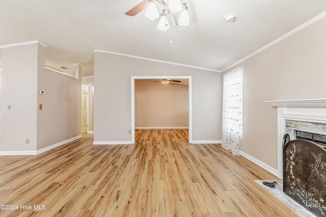 unfurnished living room featuring ceiling fan, crown molding, vaulted ceiling, a textured ceiling, and light wood-type flooring