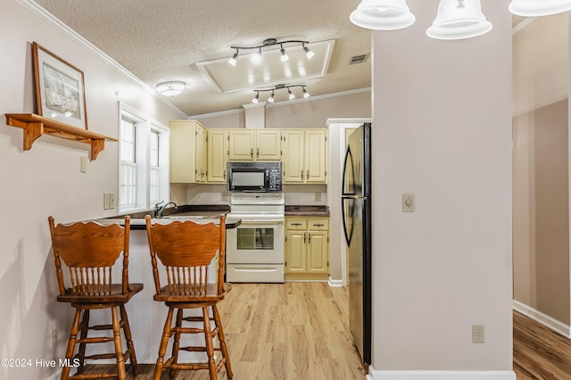 kitchen with white stove, crown molding, vaulted ceiling, light hardwood / wood-style floors, and stainless steel refrigerator