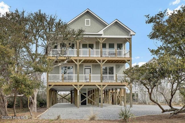 beach home with a carport, stairway, and covered porch