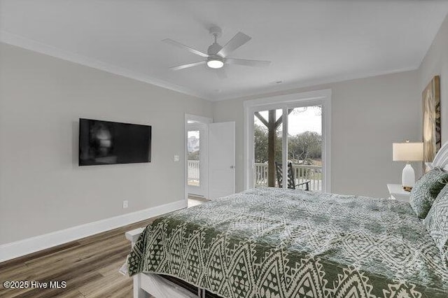 bedroom featuring wood finished floors, crown molding, baseboards, and access to outside