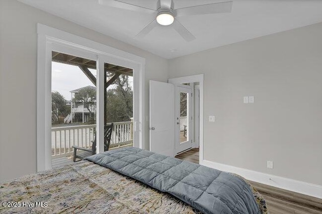 bedroom featuring baseboards, wood finished floors, a ceiling fan, and access to outside