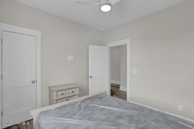 bedroom with a ceiling fan and baseboards