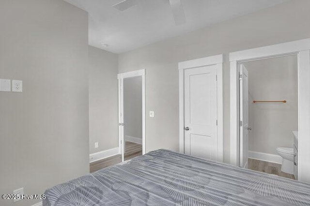 bedroom with wood finished floors, baseboards, and ceiling fan