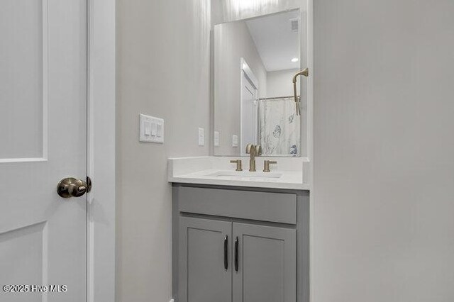 bathroom with ceiling fan, wood-type flooring, and vanity