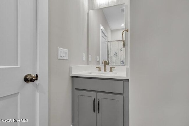 bathroom featuring vanity and curtained shower