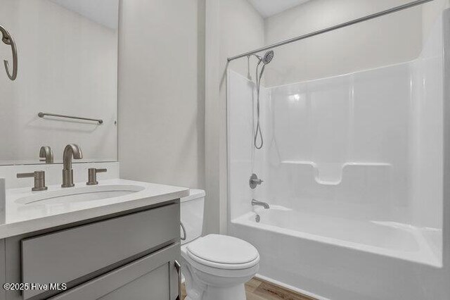 full bathroom with vanity, shower / bathtub combination, toilet, and wood-type flooring