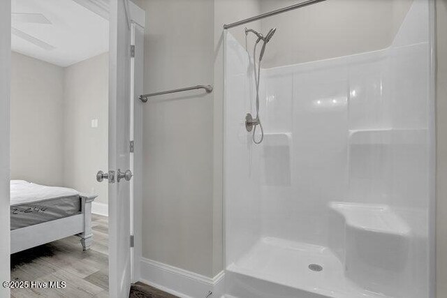 bathroom with hardwood / wood-style floors and elevator