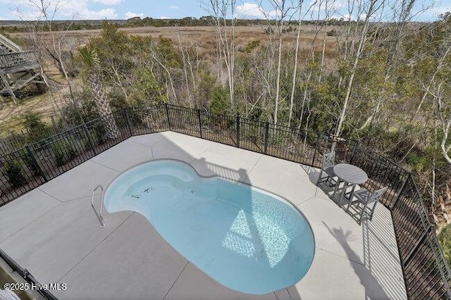 view of pool featuring a patio, fence, and a fenced in pool