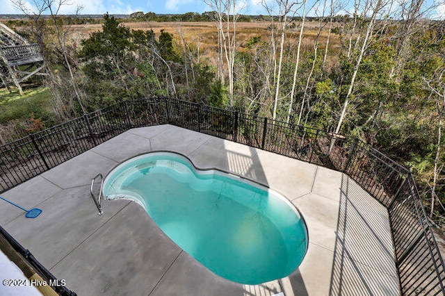 view of swimming pool featuring a patio area