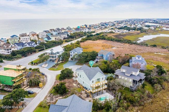 drone / aerial view with a water view and a residential view