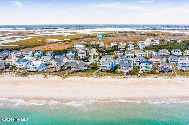 aerial view with a residential view, a beach view, and a water view