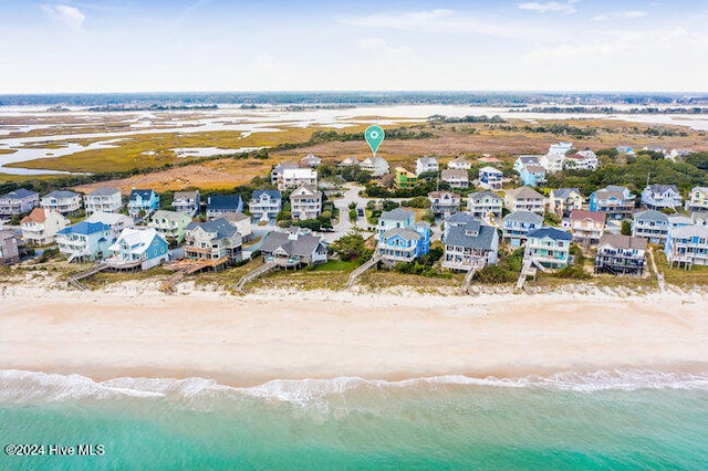 bird's eye view featuring a water view and a beach view