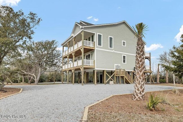 exterior space with stairway and a balcony