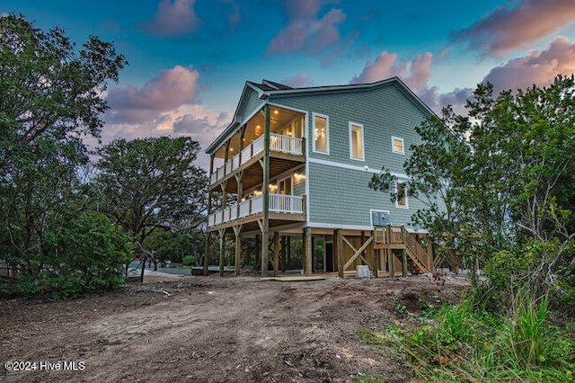 back house at dusk with a balcony