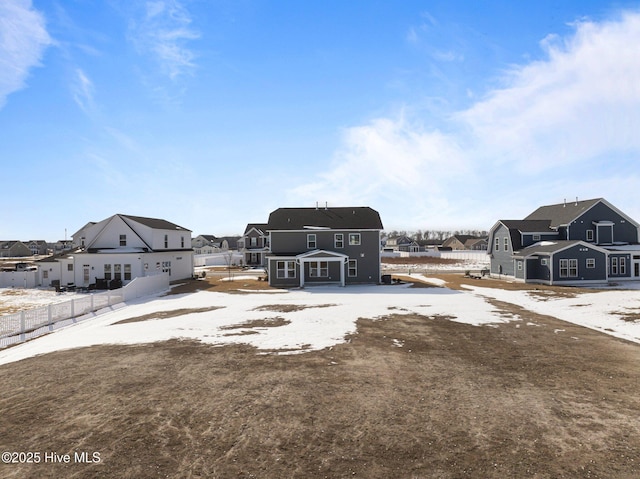 view of yard with a residential view, fence, and an outbuilding