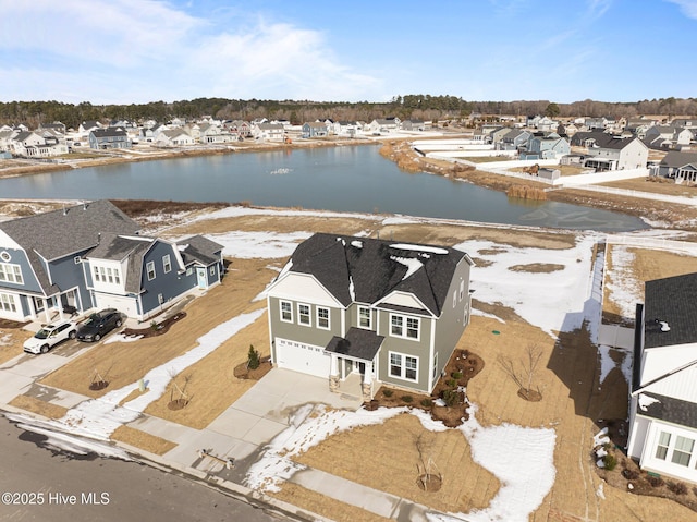 birds eye view of property featuring a water view and a residential view