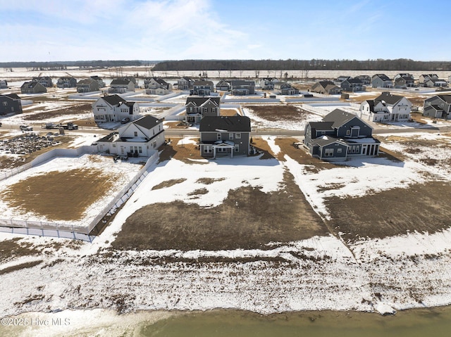 snowy aerial view featuring a residential view