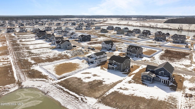 snowy aerial view with a residential view