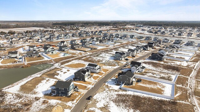 snowy aerial view with a residential view