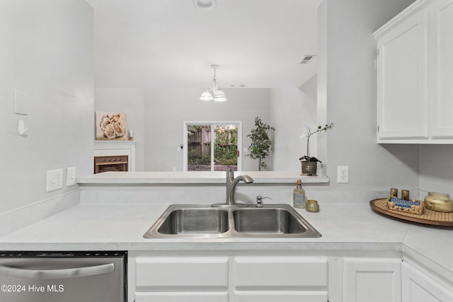 kitchen with white cabinets, stainless steel dishwasher, and sink