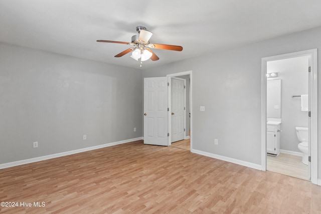 unfurnished bedroom featuring ensuite bath, ceiling fan, and light hardwood / wood-style flooring