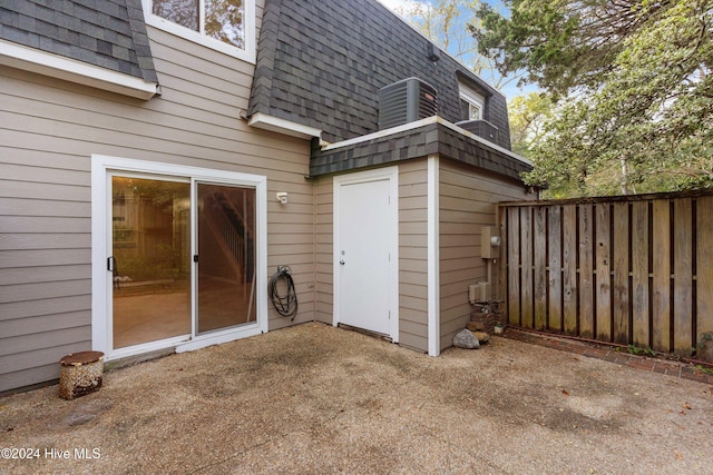 view of exterior entry with a patio area