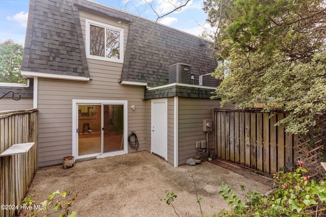 back of property featuring central AC and a patio