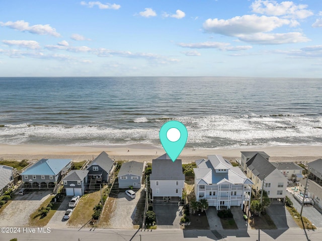 bird's eye view with a residential view, a water view, and a beach view