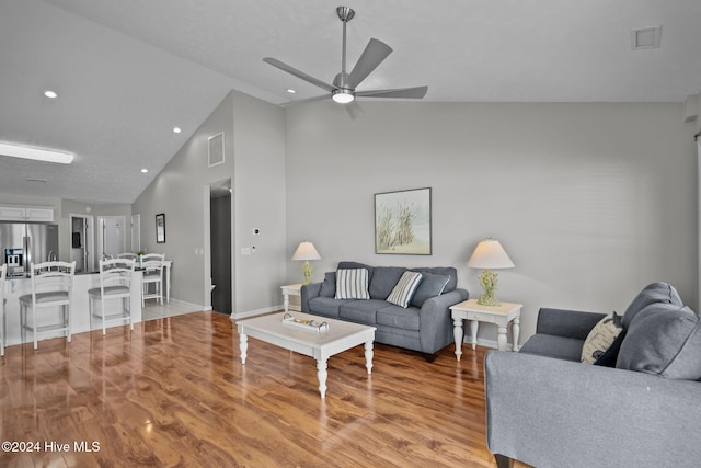 living area with light wood finished floors, visible vents, ceiling fan, recessed lighting, and high vaulted ceiling