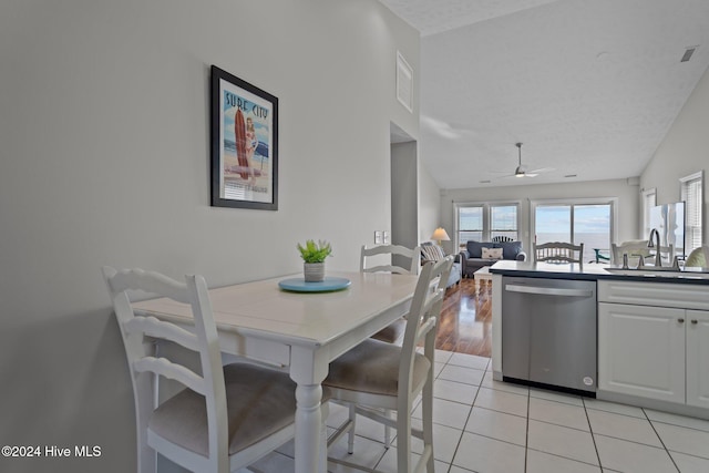 dining space with visible vents, a textured ceiling, light tile patterned flooring, and a ceiling fan