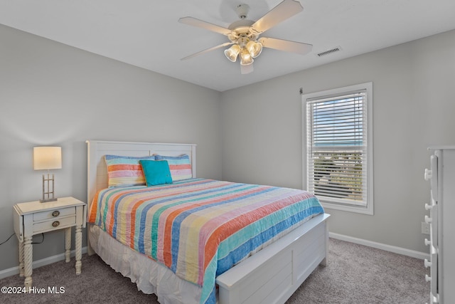 carpeted bedroom featuring visible vents, a ceiling fan, and baseboards