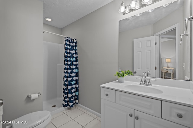 full bathroom with vanity, a stall shower, tile patterned flooring, a textured ceiling, and toilet